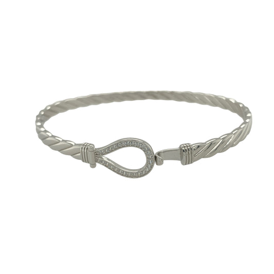 Bring refined sparkle and timeless charm to your collection with this new 925 silver cubic zirconia horseshoe bangle, a beautifully symbolic design representing luck and positivity.

Design: The bangle features a 12mm high front with a classic horseshoe motif, adorned with sparkling cubic zirconia stones for a radiant and elegant finish.
Material: Made from solid 925 sterling silver, the polished surface enhances the brilliance of the stones and gives the piece a sleek, sophisticated appearance.