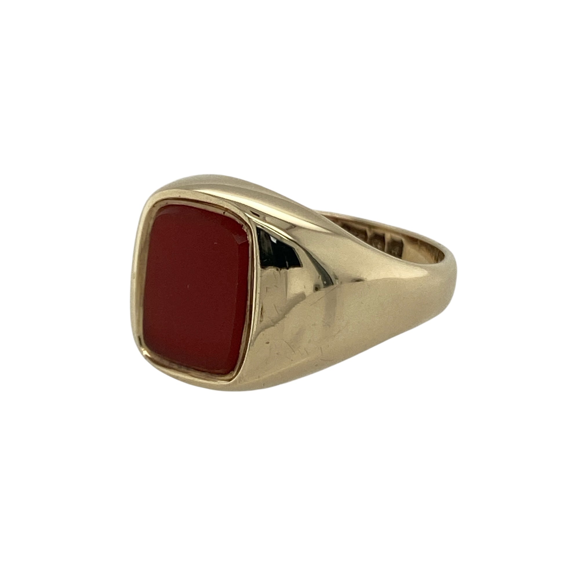 Bring warmth, style, and vintage charm to your collection with this pre-owned 9ct yellow gold carnelian signet ring—a refined piece that blends timeless design with rich, earthy colour.

Design: The ring features a rectangular carnelian gemstone measuring 9mm by 7mm, displaying its signature deep orange-red hue that symbolises vitality and strength. The smooth, polished surface gives the ring a sleek and elegant finish.