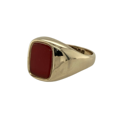 Bring warmth, style, and vintage charm to your collection with this pre-owned 9ct yellow gold carnelian signet ring—a refined piece that blends timeless design with rich, earthy colour.

Design: The ring features a rectangular carnelian gemstone measuring 9mm by 7mm, displaying its signature deep orange-red hue that symbolises vitality and strength. The smooth, polished surface gives the ring a sleek and elegant finish.
