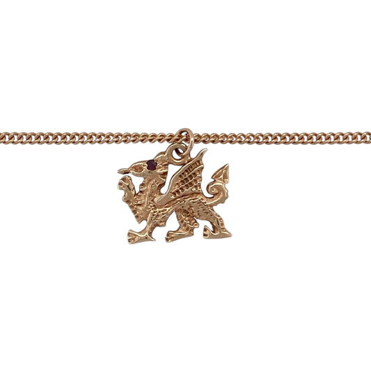 Bring heritage, strength, and refined detail to your collection with this pre-owned 9ct rose gold Welsh Dragon pendant on an 18" curb chain necklace—a striking piece that proudly celebrates Welsh identity and craftsmanship.

Design: The pendant features the iconic Welsh Dragon, beautifully formed in warm rose gold and adorned with a small ruby set as the dragon’s eye for a touch of vibrant colour and distinction. The detailed design captures the strength and spirit of this national symbol.