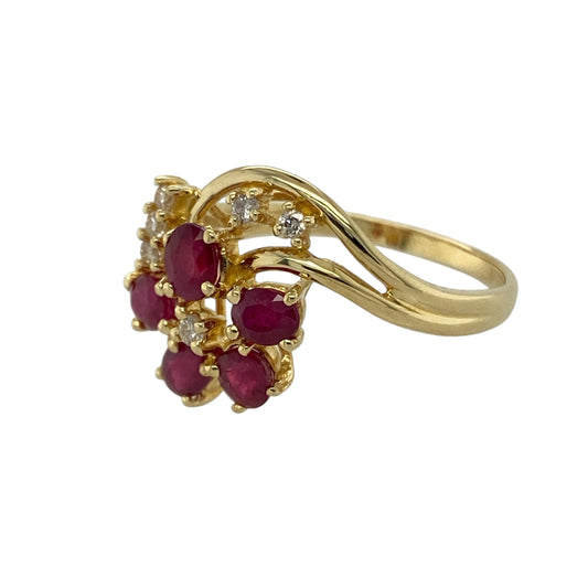 Bring colour, sparkle, and timeless elegance to your collection with this pre-owned 18ct yellow gold diamond and ruby flower style ring—a stunning piece that combines classic beauty with refined craftsmanship.

Design: The ring features a floral-inspired cluster design with vibrant rubies forming the petals and sparkling diamonds accenting the arrangement, creating a radiant display of colour and brilliance. The intricate setting enhances the vintage charm and elegance of the piece.