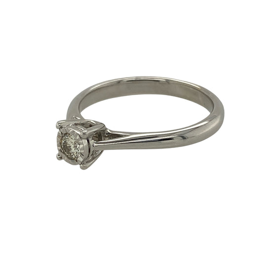 Bring timeless elegance and refined sparkle to your collection with this pre-owned 9ct white gold diamond illusion-set solitaire ring—a classic design that exudes sophistication and charm.

Design: The ring features an illusion-set diamond centre with an approximate total diamond weight of 0.11ct, designed to maximise brilliance and create the look of a larger stone. The clean, elegant setting enhances the diamond’s natural radiance and offers enduring appeal.