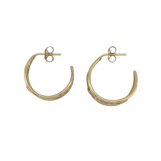 Bring elegance, warmth, and symbolic beauty to your collection with these pre-owned 9ct yellow and rose Welsh gold Vine of Life half hoop stud earrings—a graceful design inspired by nature and renewal.

Design: The earrings feature Clogau’s signature Vine of Life motif, with intertwining vines of yellow and rose gold symbolising growth, strength, and connection. The half-hoop shape offers a timeless and flattering look suitable for any occasion.