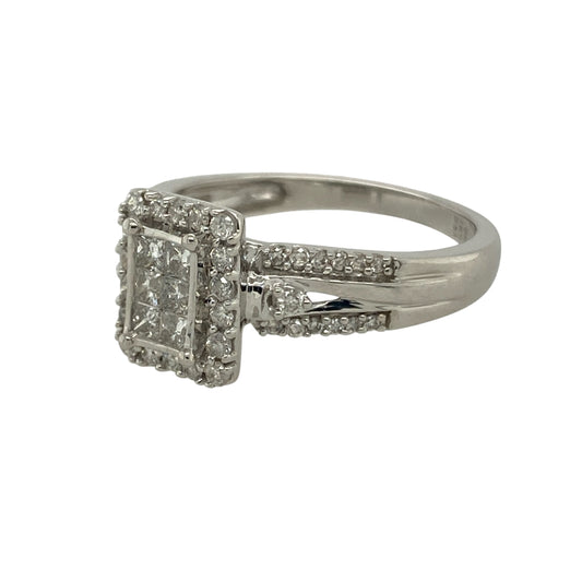 
Bring brilliance and modern sophistication to your collection with this pre-owned 9ct white gold diamond rectangle halo ring—a stunning piece that combines contemporary design with timeless sparkle.

Design: The ring features six princess-cut diamonds at the centre, arranged in a rectangular formation and surrounded by a halo of smaller diamonds for maximum radiance. Additional diamonds set along the shoulders complete the look, giving the ring a luxurious, light-catching finish.