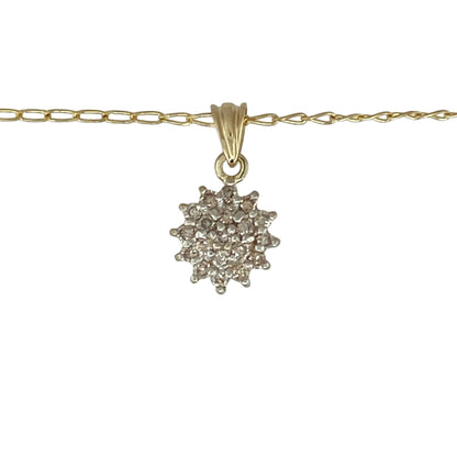 Bring timeless sparkle and refined elegance to your collection with this pre-owned 9ct yellow gold diamond cluster pendant on a 16" curb chain necklace—a beautifully classic piece that radiates sophistication.

Design: The pendant features a dazzling cluster of diamonds with a total diamond weight of approximately 0.25ct, creating a brilliant centrepiece that catches the light from every angle. The delicate arrangement enhances both sparkle and depth, offering a graceful, timeless look.