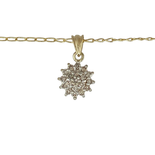 Bring timeless sparkle and refined elegance to your collection with this pre-owned 9ct yellow gold diamond cluster pendant on a 16" curb chain necklace—a beautifully classic piece that radiates sophistication.

Design: The pendant features a dazzling cluster of diamonds with a total diamond weight of approximately 0.25ct, creating a brilliant centrepiece that catches the light from every angle. The delicate arrangement enhances both sparkle and depth, offering a graceful, timeless look.