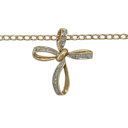 Bring grace, sparkle, and timeless meaning to your collection with this pre-owned 9ct yellow gold diamond open bow style cross pendant on an 18" curb chain necklace—a refined piece that beautifully combines faith with elegant design.

Design: The pendant features an open cross design with soft bow-shaped curves, delicately accented with sparkling diamonds for a touch of brilliance. Measuring approximately 2.7cm long, it offers a graceful and feminine interpretation of a classic symbol.