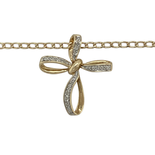 Bring grace, sparkle, and timeless meaning to your collection with this pre-owned 9ct yellow gold diamond open bow style cross pendant on an 18" curb chain necklace—a refined piece that beautifully combines faith with elegant design.

Design: The pendant features an open cross design with soft bow-shaped curves, delicately accented with sparkling diamonds for a touch of brilliance. Measuring approximately 2.7cm long, it offers a graceful and feminine interpretation of a classic symbol.