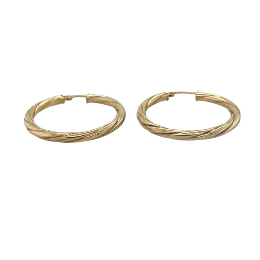 Bring timeless elegance and radiant shine to your collection with these pre-owned 9ct yellow gold twisted hoop creole earrings, combining classic design with refined detail—perfect for everyday wear or special occasions.

Design: The earrings feature a graceful twisted hoop creole design that reflects the light beautifully, adding texture and dimension to a traditional silhouette.