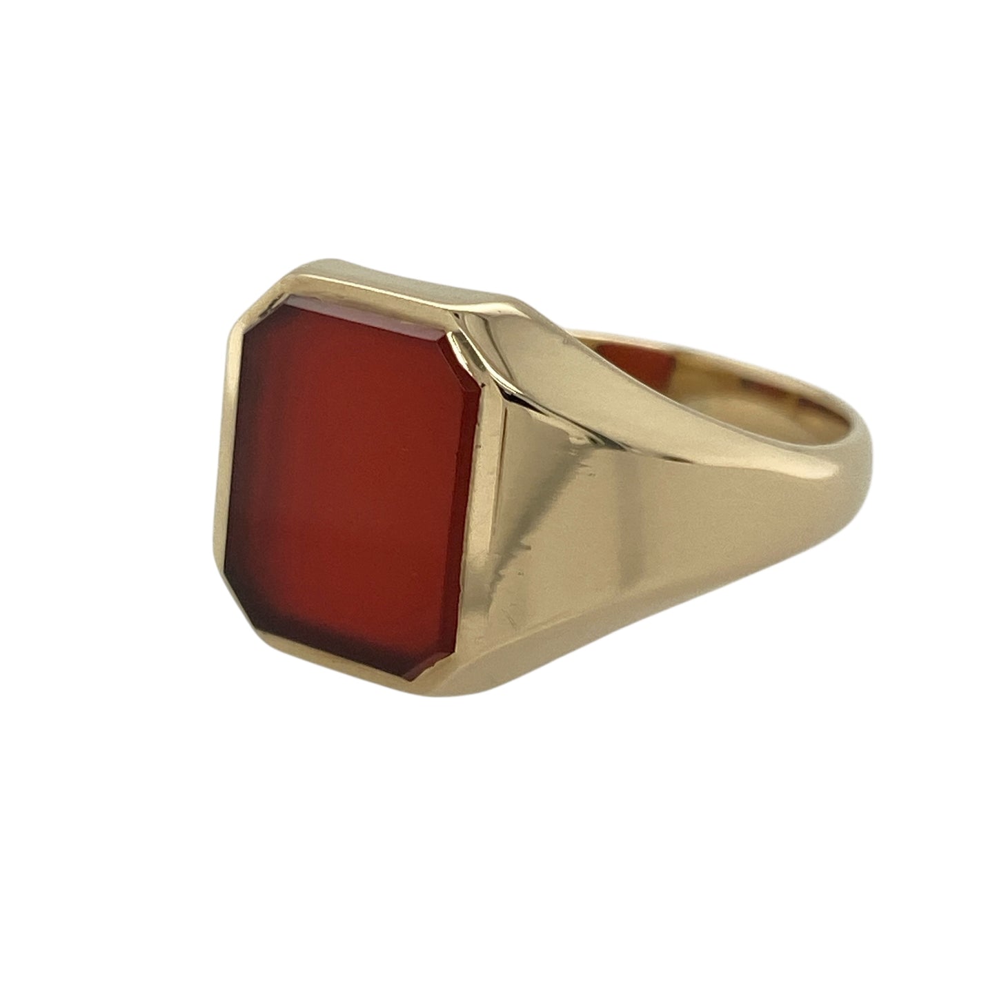 Bring rich colour and timeless elegance to your collection with this pre-owned 9ct yellow gold and carnelian signet ring, combining classic design with refined sophistication—perfect for both everyday wear and special occasions.

Design: The ring features a rectangular carnelian stone measuring 12mm by 10mm, displaying deep, warm orange-red tones that create a striking contrast against the gold.