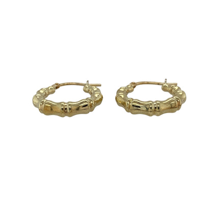 Bring stylish texture and classic charm to your collection with these pre-owned 9ct yellow gold bamboo-style hoop creole earrings, combining a timeless silhouette with a distinctive design—perfect for everyday wear or elegant occasions.

Design: Each earring features a traditional creole hoop shape with a detailed bamboo-style pattern, adding depth, character, and a touch of natural-inspired elegance.
