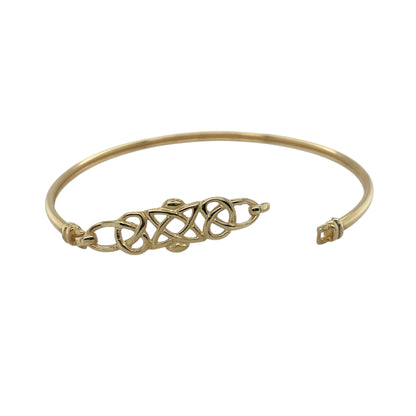 Bring symbolic elegance and timeless design to your collection with this pre-owned 9ct yellow gold Celtic knot bangle, combining traditional artistry with refined style—perfect for both everyday wear and special occasions.

Design: The bangle features an intricate Celtic knot motif at the front, measuring 10mm high, symbolising eternity and interconnectedness. The rest of the bangle flows into a smooth, polished band for a balanced and elegant look.