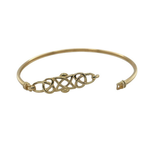 Bring symbolic elegance and timeless design to your collection with this pre-owned 9ct yellow gold Celtic knot bangle, combining traditional artistry with refined style—perfect for both everyday wear and special occasions.

Design: The bangle features an intricate Celtic knot motif at the front, measuring 10mm high, symbolising eternity and interconnectedness. The rest of the bangle flows into a smooth, polished band for a balanced and elegant look.