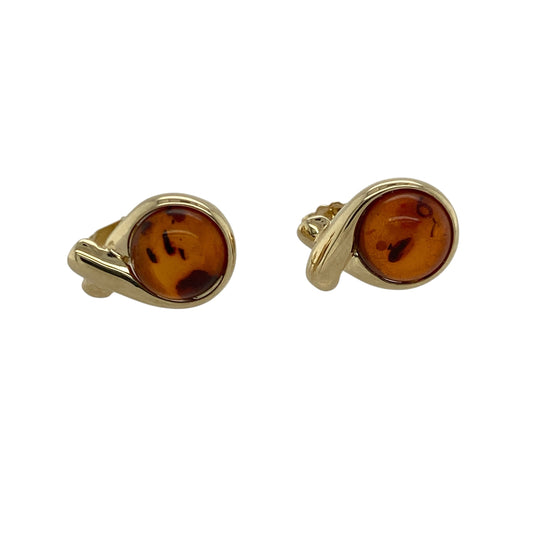Bring warm colour and vintage-inspired elegance to your style with these pre-owned 9ct yellow gold and amber twist stud earrings—perfect for adding a touch of natural beauty to any look.

Design: Each earring showcases an 8mm amber stone held within an elegant twisted gold frame, highlighting the stone’s rich golden-brown tones and natural inclusions. The twist design adds movement and sophistication to this classic style.