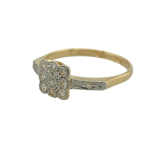 Bring vintage charm and refined sparkle to your collection with this pre-owned 18ct yellow gold and platinum set Art Deco cluster ring—perfect for lovers of timeless elegance and classic design.

Design: The ring features a 7mm-high cluster centre inspired by the geometric beauty of the Art Deco era, complemented by diamonds set along the shoulders for added brilliance and sophistication. The structured lines and balanced proportions reflect the enduring appeal of early 20th-century style.
