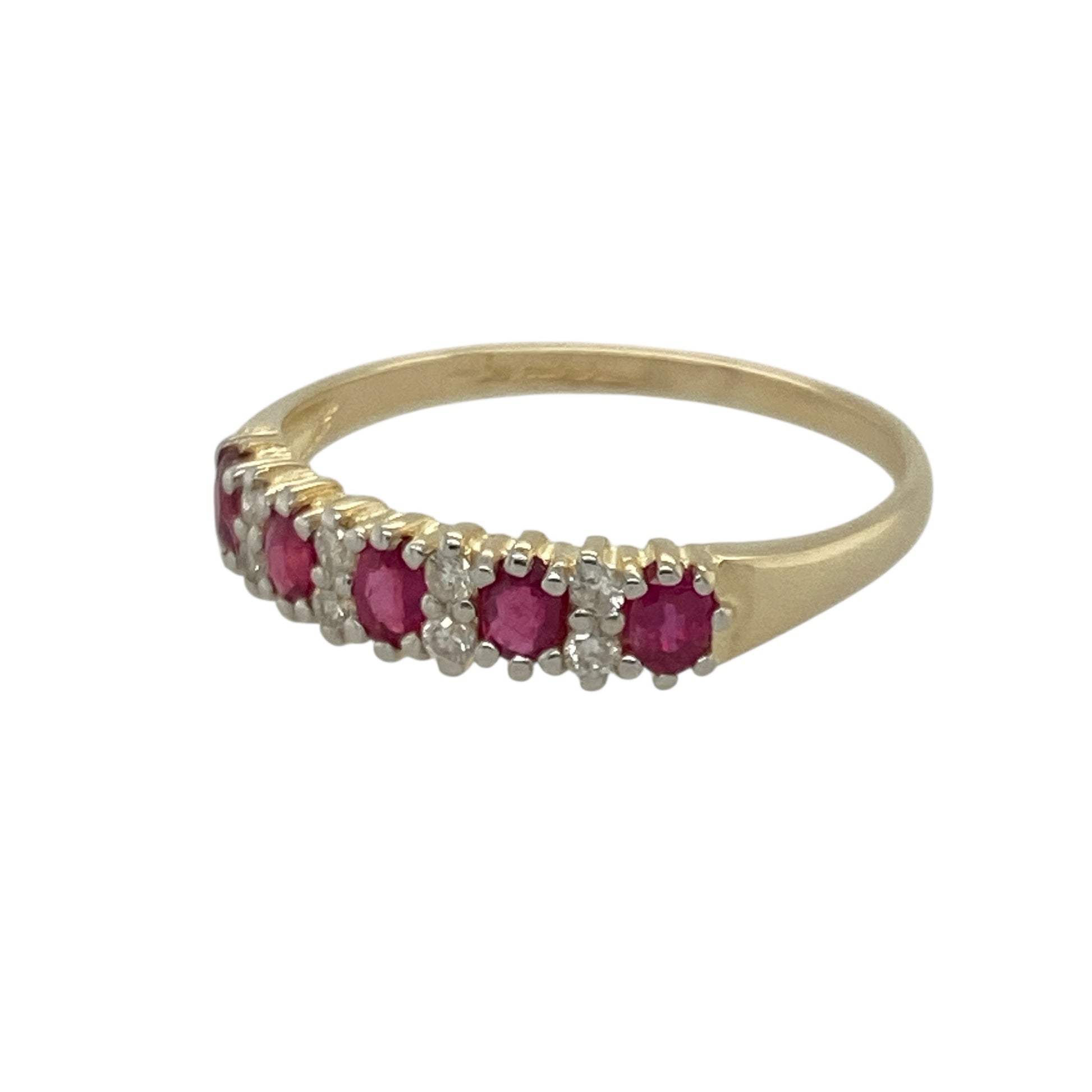 Bring vibrant colour and timeless sparkle to your collection with this pre-owned 9ct yellow gold diamond and ruby set band ring—perfect for adding classic elegance to any occasion.

Design: The ring features a series of 3mm by 2mm oval-cut rubies, each separated by two sparkling diamonds, creating a beautifully balanced design rich in colour and brilliance. The combination of gemstones offers a refined and romantic aesthetic.