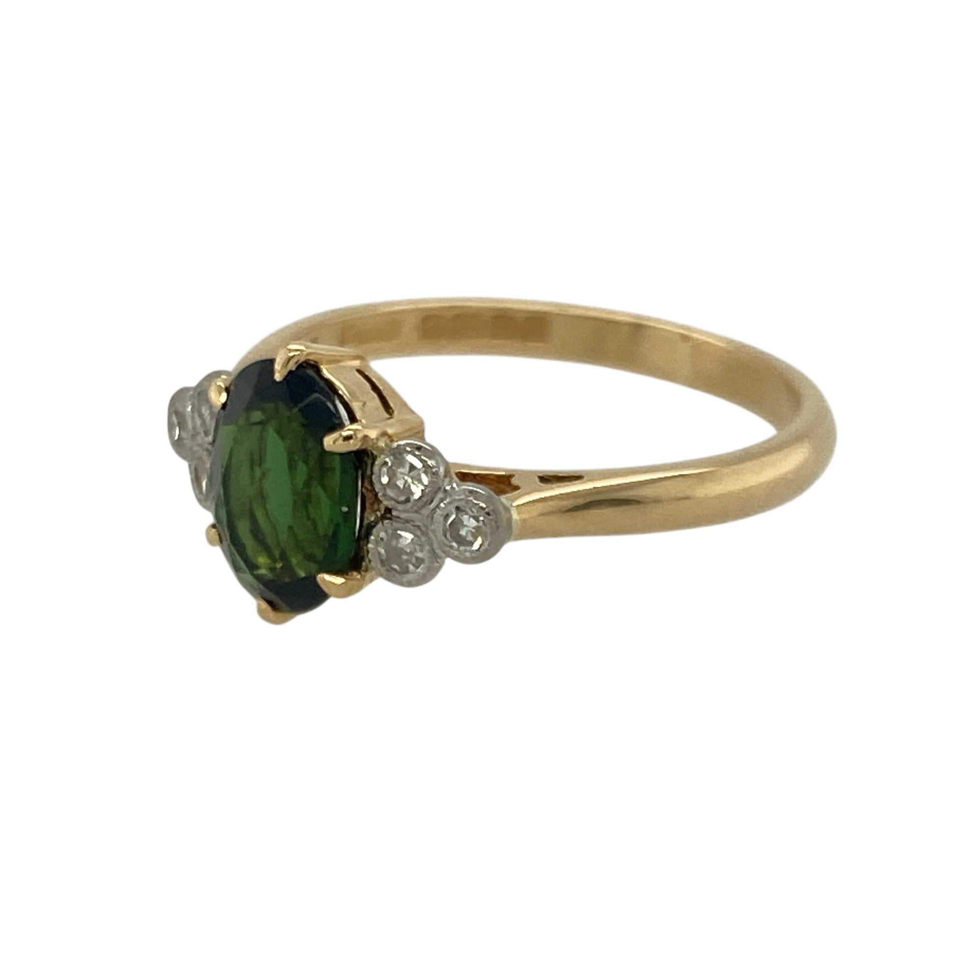 Bring rich colour and refined brilliance to your collection with this pre-owned 18ct yellow gold diamond and chrome diopside set ring—perfect for adding a luxurious touch to any occasion.

Design: The ring features a striking 8mm by 6mm oval-cut chrome diopside at its centre, radiating a vivid deep green hue. Sparkling diamonds accent the design, enhancing the gemstone’s rich colour and creating an elegant, balanced look.