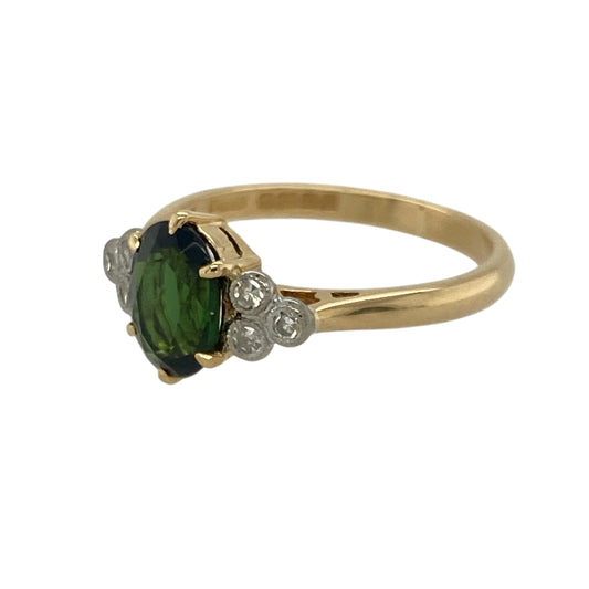 Bring rich colour and refined brilliance to your collection with this pre-owned 18ct yellow gold diamond and chrome diopside set ring—perfect for adding a luxurious touch to any occasion.

Design: The ring features a striking 8mm by 6mm oval-cut chrome diopside at its centre, radiating a vivid deep green hue. Sparkling diamonds accent the design, enhancing the gemstone’s rich colour and creating an elegant, balanced look.