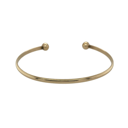 Bring sleek style and classic elegance to your collection with this pre-owned 9ct solid yellow gold torque bangle—perfect for everyday wear or adding a timeless finishing touch to any outfit.

Design: The bangle features a smooth 3mm-wide band finished with two 6mm polished gold balls at each end, creating the signature open torque style. Its simple yet sophisticated design offers versatility and enduring appeal.