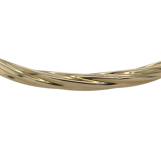 Bring classic elegance and subtle texture to your collection with this pre-owned 9ct yellow gold twisted bangle—perfect for adding timeless sophistication to any look.

Design: The bangle features a 4mm-wide band with a graceful twisted design, creating a beautiful interplay of light and texture for a refined and stylish finish.
Material: Made from 9-carat yellow gold, the warm tone enhances the twisted pattern and provides lasting shine and durability.