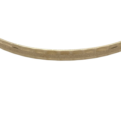 Bring understated elegance and subtle texture to your collection with this pre-owned 9ct yellow solid gold patterned bangle — a refined accessory that adds a touch of sophistication to any look.

Design: The bangle features a delicately patterned finish along its surface, offering a beautiful play of light and a timeless decorative appeal.
Material: Made from solid 9-carat yellow gold, the warm tone enhances the intricate detailing and gives the piece a luxurious yet versatile charm.