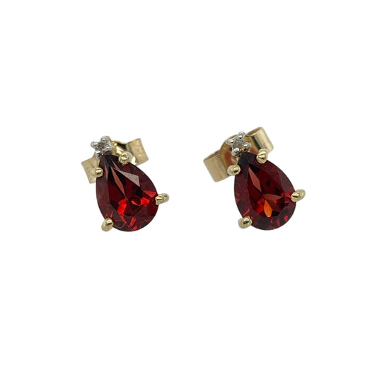 Add rich warmth and classic sparkle to your collection with these pre-owned 9ct yellow gold diamond and garnet set stud earrings — a timeless design that exudes elegance and sophistication.

Design: Each earring features a 7mm by 5mm teardrop-shaped garnet, beautifully accented by a sparkling diamond that enhances the deep red tones of the gemstones and adds a touch of brilliance.