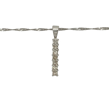 Add refined sparkle and modern elegance to your collection with this pre-owned 9ct white gold seven-stone diamond set bar pendant on an 18" Singapore chain necklace — a sleek and timeless design perfect for any occasion.

Design: The pendant features a vertical bar set with seven sparkling diamonds, creating a clean, contemporary look that catches the light beautifully. Measuring 2cm long including the bail, it offers understated sophistication with radiant sparkle.