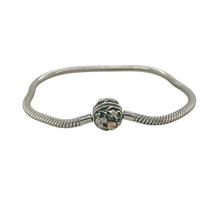 Add contemporary charm and signature Clogau style to your collection with this pre-owned 925 silver bead charm bracelet — a versatile piece perfect for personal expression and everyday elegance.

Design: The bracelet features a polished silver bead design with a distinctive clasp adorned with green enamel detailing, adding a subtle pop of colour and a unique Clogau touch.
