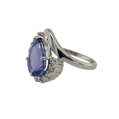 Pre-owned 18ct White Gold Diamond &amp; Tanzanite Set Teardrop Twist Ring in size L with the weight 3.60 grams. The teardrop tanzanite stone is 10mm by 7mm