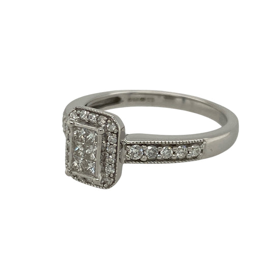 Pre-owned 9ct White Gold &amp; Diamond Rectangle shape Halo Ring in size M with the weight 3.20 grams. The front of the ring is 9mm high and the ring is made up of six princess cut diamonds in the center with a halo of brilliant cut diamonds and diamond set on the shoulders. There is approximately 0.38ct of diamond content set in total