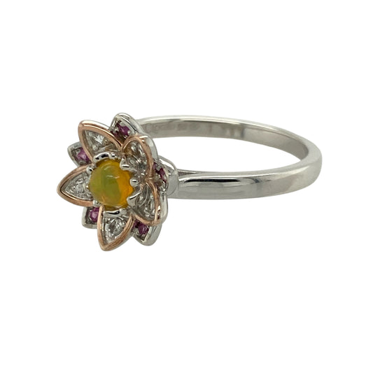 Embrace harmony and radiant colour with this pre-owned 925 silver and 9ct rose gold Clogau Lotus Flower ring, symbolising purity and enlightenment—perfect for adding a touch of beauty and meaning to your jewellery collection.

Design: The ring features an intricate lotus flower motif measuring 12mm high, with a warm yellow topaz at the centre surrounded by delicate white and pink topaz stones set within the petals, creating a soft, graceful palette of colour and sparkle.