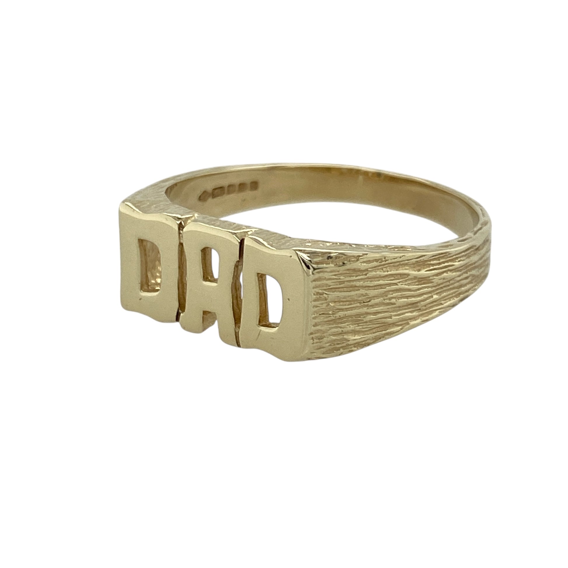 Celebrate sentiment and classic style with this pre-owned 9ct yellow gold Dad ring, a timeless piece that combines bold design with meaningful charm—perfect as a treasured keepsake or thoughtful gift.

Design: The ring features the word DAD across the front, measuring 8mm high, with textured shoulders that add depth and character to the design.
Material: Made from 9-carat yellow gold, the polished finish enhances the warm tone of the metal and gives the piece a refined yet masculine look.