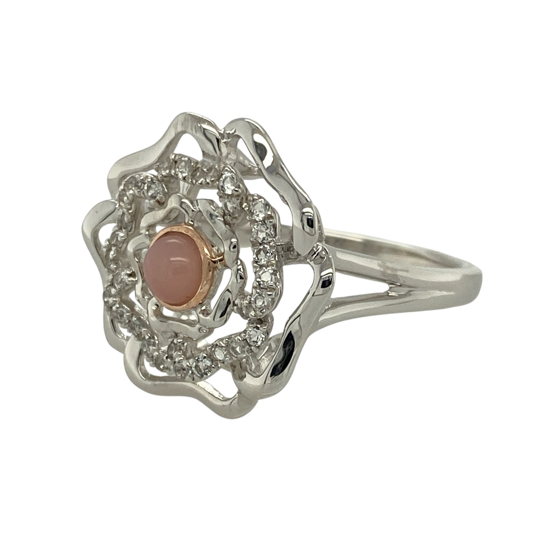 Bring feminine charm and radiant colour to your collection with this pre-owned 925 silver with 9ct rose gold, white topaz, and pink stone Clogau flower ring—a beautifully detailed design inspired by nature’s elegance.

Design: The ring features a 4mm round pink stone at the centre of a delicate flower motif, surrounded by sparkling white topaz accents that enhance its soft, romantic glow.