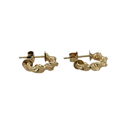 Add subtle elegance and timeless shine to your look with these pre-owned 9ct yellow gold twisted half hoop stud earrings, combining classic style with a modern twist—perfect for everyday wear or special occasions.

Design: Each earring features a refined half-hoop shape with a delicate twisted design, adding texture and light-catching movement for understated sophistication.
Material: Made from 9-carat yellow gold, the polished finish enhances the warm golden tone and provides a radiant glow.