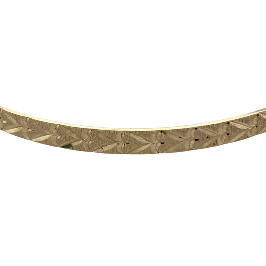 Bring romantic charm and timeless shine to your collection with this pre-owned 9ct yellow solid gold heart-patterned bangle—an elegant piece with classic appeal.

Design: Featuring a 4mm-wide band adorned with a delicate heart pattern, the bangle offers a sweet and refined decorative finish.
Material: Made in solid 9-carat yellow gold, the polished surface enhances the patterned detailing with a warm, radiant glow.
