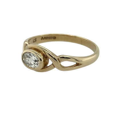 Bring graceful sparkle and modern elegance to your collection with this pre-owned 9ct yellow gold cubic zirconia open twist ring—an eye-catching piece with timeless appeal.

Design: Featuring a 4mm by 6mm oval cubic zirconia held within a flowing open twist design, the ring offers a bright, refined focal point with elegant movement.
Material: Made in 9-carat yellow gold, the polished finish enhances the twist detail and complements the stone’s clear brilliance.