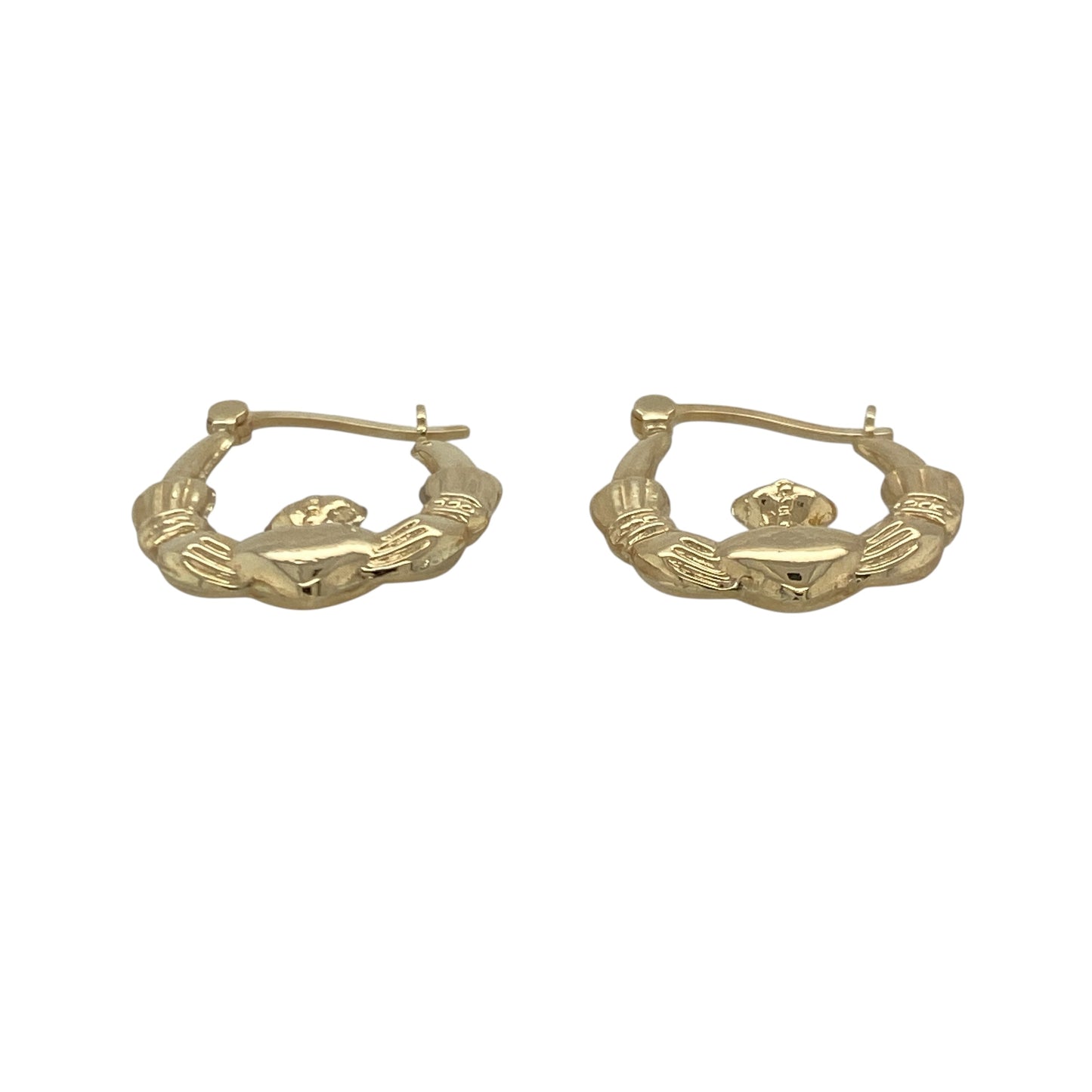 Bring meaningful symbolism and timeless charm to your collection with these pre-owned 9ct yellow gold Claddagh creole earrings—an elegant pair inspired by heritage and tradition.

Design: Featuring a classic creole hoop adorned with the iconic Claddagh motif—hands for friendship, a heart for love, and a crown for loyalty—these earrings offer a distinctive and heartfelt focal point.
Material: Made in 9-carat yellow gold, the polished finish highlights the intricate detailing with a warm, radiant shine.