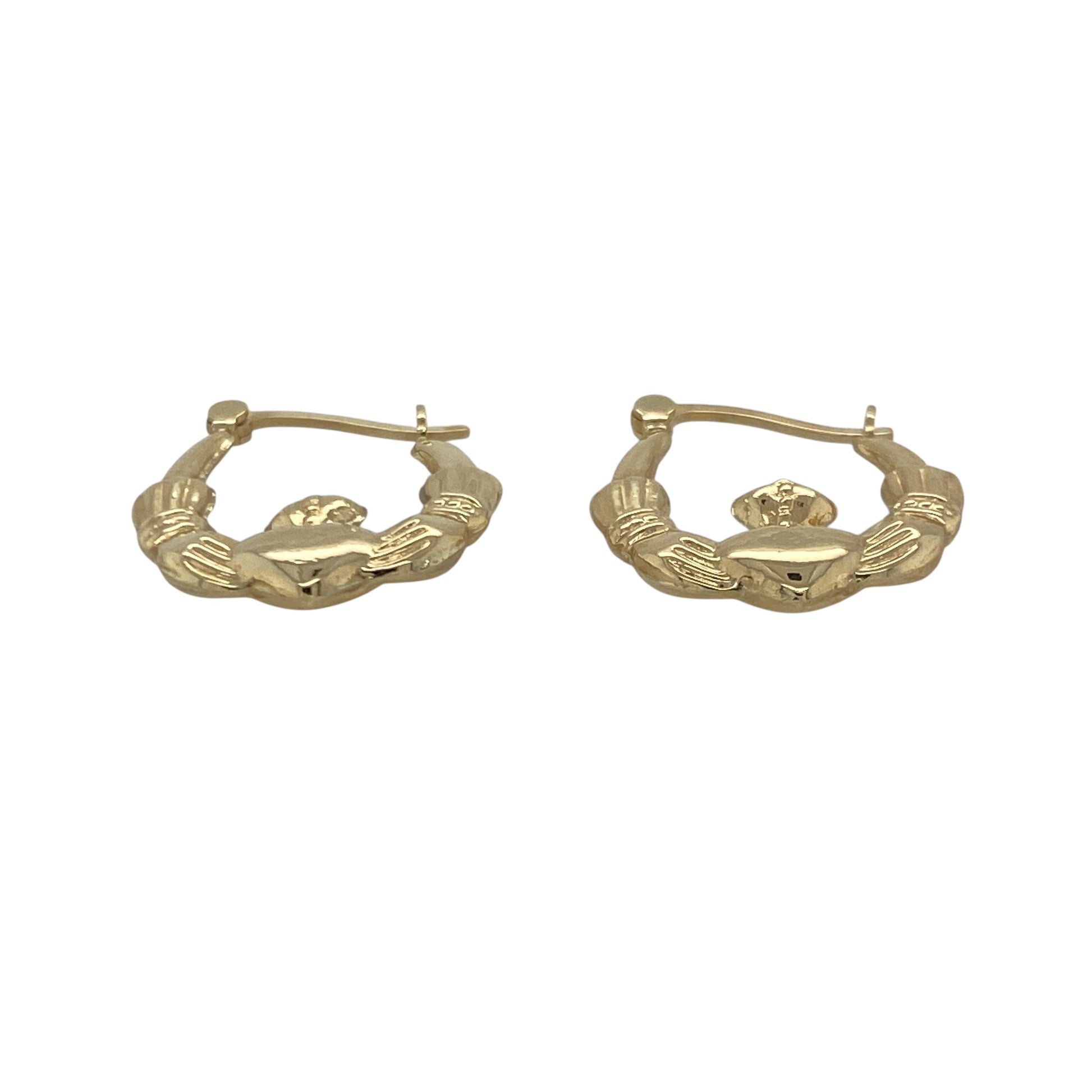 Bring meaningful symbolism and timeless charm to your collection with these pre-owned 9ct yellow gold Claddagh creole earrings—an elegant pair inspired by heritage and tradition.

Design: Featuring a classic creole hoop adorned with the iconic Claddagh motif—hands for friendship, a heart for love, and a crown for loyalty—these earrings offer a distinctive and heartfelt focal point.
Material: Made in 9-carat yellow gold, the polished finish highlights the intricate detailing with a warm, radiant shine.