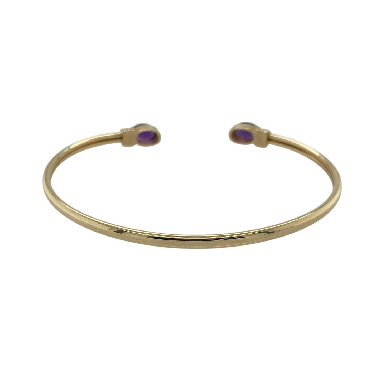 Bring vibrant colour and elegant style to your collection with this pre-owned 9ct yellow gold amethyst torque bangle—an eye-catching piece with timeless appeal.

Design: Featuring an open torque style finished with two 7mm by 5mm oval amethyst stones, the bangle offers a striking pop of purple that creates a refined and balanced focal point.
Material: Made in 9-carat yellow gold, the polished surface provides a warm contrast that enhances the richness of the amethysts.