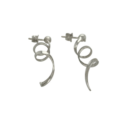 Bring modern elegance and graceful movement to your collection with these pre-owned 9ct white gold swirl drop earrings—an eye-catching pair offering contemporary style and refined shine.

Design: These earrings feature flowing swirl-shaped drops that create a sleek, sculpted look with gentle movement when worn.
Material: Made from 9-carat white gold, the cool-toned polished finish enhances their modern, radiant appeal.
