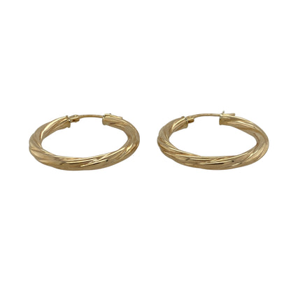 Bring elegant movement and warm golden tone to your collection with these pre-owned 9ct yellow gold twisted creole earrings—an attractive pair offering timeless style and subtle texture.

Design: These hoop creole earrings feature a twisted shape that adds depth, gentle light play, and refined visual interest to their classic form.
Material: Made from 9-carat yellow gold, the earrings display a polished, radiant finish that enhances the twist detailing.