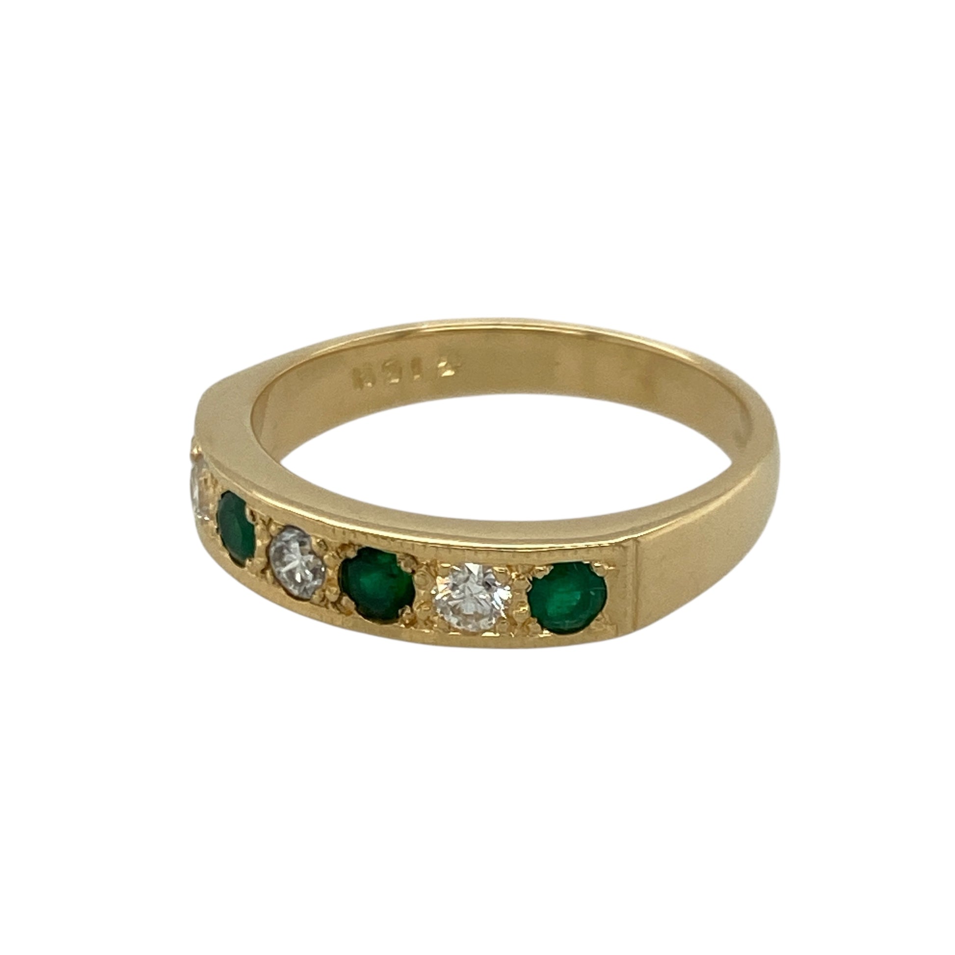 Bring rich colour and refined sparkle to your collection with this pre-owned 18ct yellow gold diamond and emerald band ring—an elegant piece offering timeless beauty and luxurious presence.

Design: This size O band features three vibrant 3mm round emeralds arranged across the front, complemented by diamonds totalling approximately 0.18ct for added brilliance and balance.