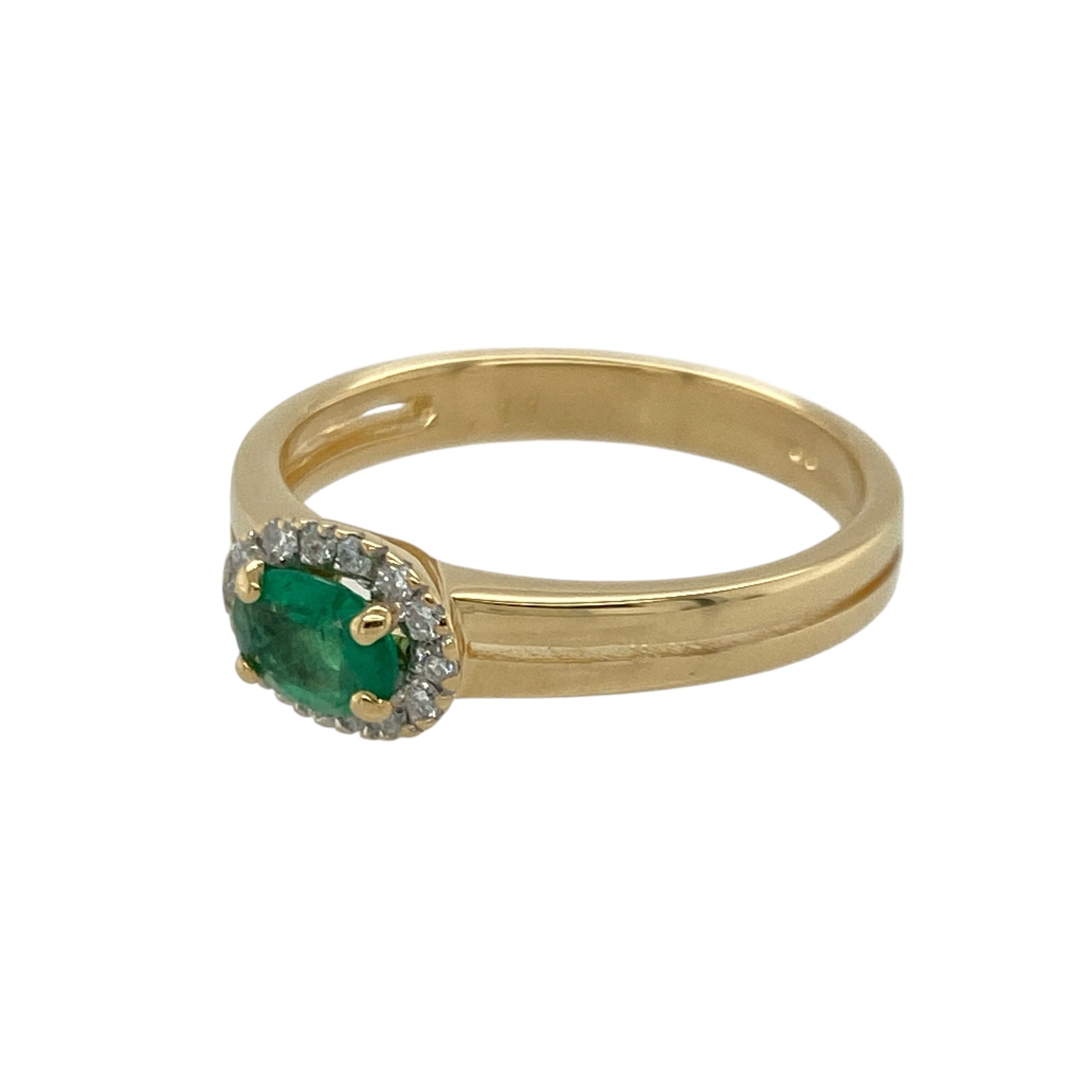Bring rich colour and elegant sparkle to your collection with this pre-owned 18ct yellow gold diamond and emerald halo ring—an exquisite piece offering timeless beauty and refined sophistication.

Design: This size O ring features a 4mm by 6mm oval emerald at the centre, surrounded by a halo of diamonds totalling approximately 0.11ct, enhancing the gemstone’s vivid green hue with bright, eye-catching brilliance.