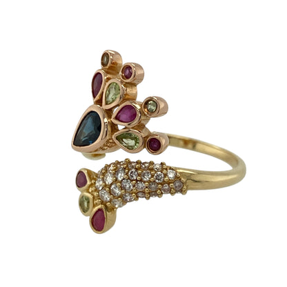 Bring vibrant colour and enchanting detail to your collection with this pre-owned 18ct yellow gold Clogau peacock wrap-around ring—an expressive piece offering symbolic beauty, rich gemstones, and luxurious craftsmanship.

Design: This size S ring features a striking peacock-inspired wrap-around design approximately 2.2cm high, adorned with diamonds, rubies, peridots, and sapphires to create a vivid, flowing display of colour and elegance.
