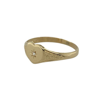Bring sweet sparkle and warm golden charm to your collection with this pre-owned 9ct yellow gold diamond heart signet ring—an elegant piece offering delicate detail and timeless appeal.

Design: This size I ring features a 6mm high heart-shaped signet front, accented with a sparkling diamond for a subtle, romantic touch.
Material: Made from 9-carat yellow gold, the polished finish enhances its soft, radiant shine and complements the diamond’s gentle brilliance.