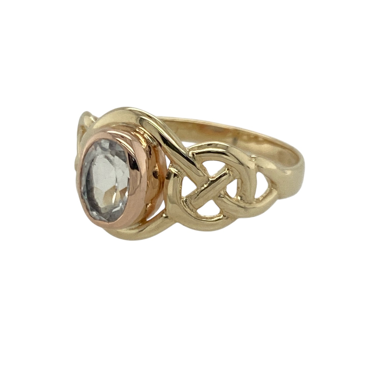 Bring meaningful design and vibrant colour to your collection with this pre-owned 9ct yellow and rose gold Clogau knot ring—an elegant piece offering symbolic style and refined gemstone beauty.

Design: This size M ring features a 7mm by 5mm oval topaz at the centre, framed by a flowing Clogau knot motif that represents unity, continuity, and connection.
Material: Made from 9-carat yellow and rose gold, the warm mixed-metal tones beautifully complement the bright, crisp blue of the topaz.