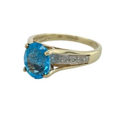 Bring bold colour and elegant sparkle to your collection with this pre-owned 9ct yellow gold blue stone and diamond ring—an eye-catching piece offering timeless style and refined presence.

Design: This size R ring features a striking 10mm by 8mm oval blue stone at the centre, accented with diamonds that enhance its rich colour and create a balanced, radiant look.
Material: Made from 9-carat yellow gold, the polished finish provides a warm, classic glow that complements the vivid blue centre stone.