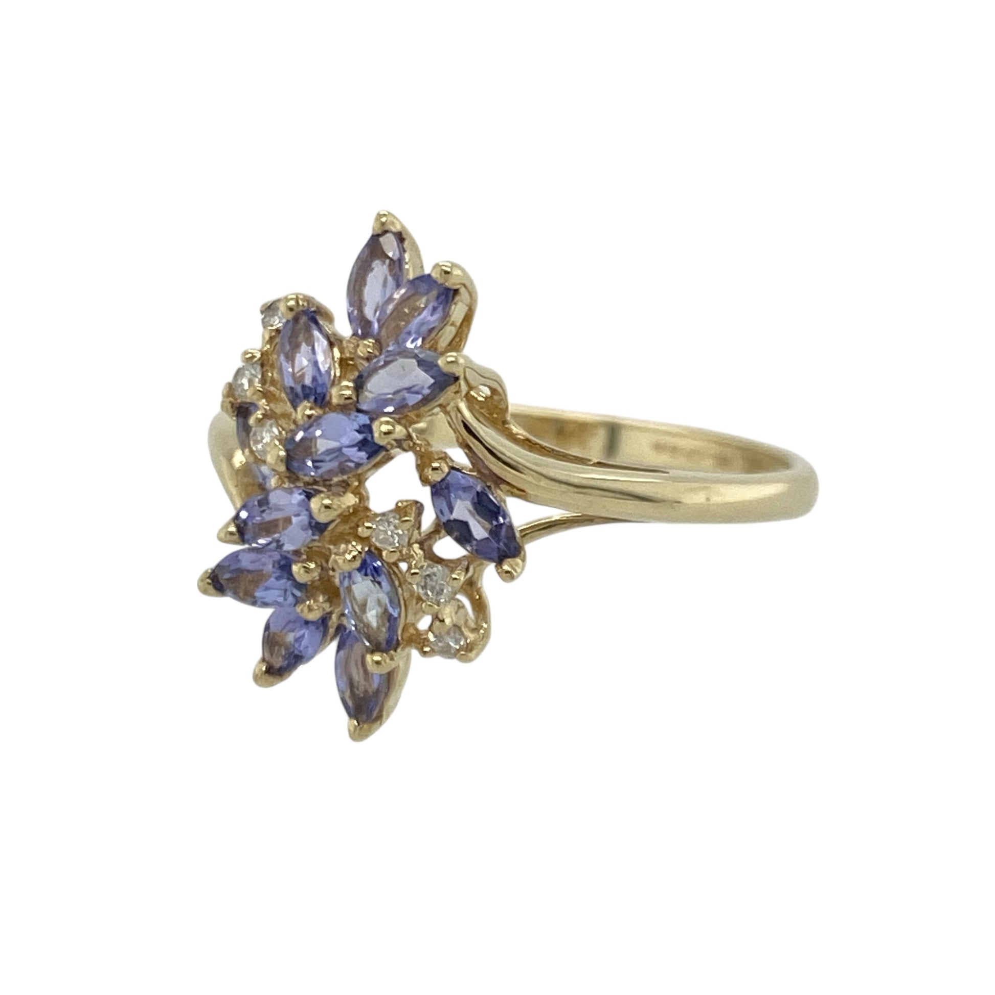 Bring vibrant colour and graceful sparkle to your collection with this pre-owned 9ct yellow gold tanzanite and diamond flower ring—an elegant piece offering eye-catching beauty and timeless charm.

Design: This size S ring features a 17mm high floral-style arrangement of tanzanite stones accented with diamonds, creating a striking, light-catching display with a soft, feminine feel.