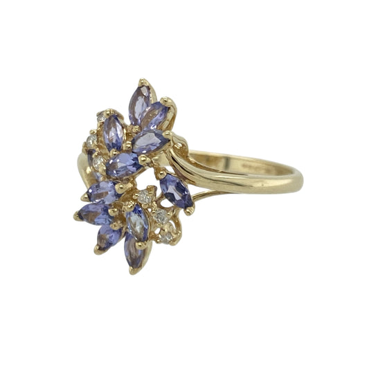 Bring vibrant colour and graceful sparkle to your collection with this pre-owned 9ct yellow gold tanzanite and diamond flower ring—an elegant piece offering eye-catching beauty and timeless charm.

Design: This size S ring features a 17mm high floral-style arrangement of tanzanite stones accented with diamonds, creating a striking, light-catching display with a soft, feminine feel.