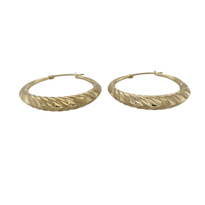 Bring elegant texture and warm golden shine to your collection with these pre-owned 9ct yellow gold patterned twisted creole earrings—an eye-catching pair offering timeless style and refined detail.

Design: These hoop creole earrings feature a twisted shape with decorative patterning, creating depth, movement, and a distinctive light-catching finish.
Material: Made from 9-carat yellow gold, the polished surfaces enhance the rich golden tone and highlight the intricate twist and pattern details.